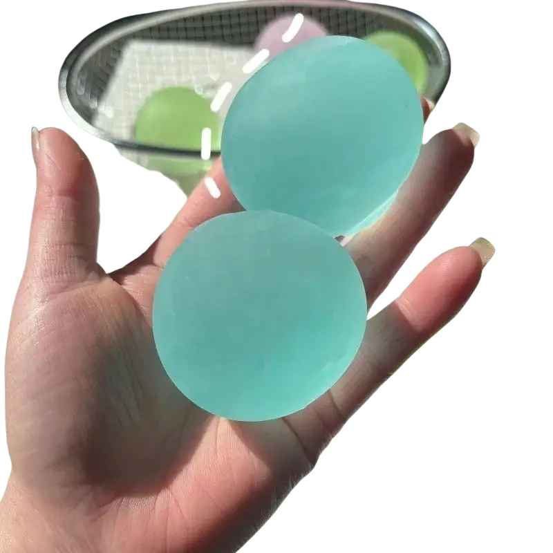 Two translucent light blue mochi squeeze sensory fidget toy stress balls held in a hand for stress relief