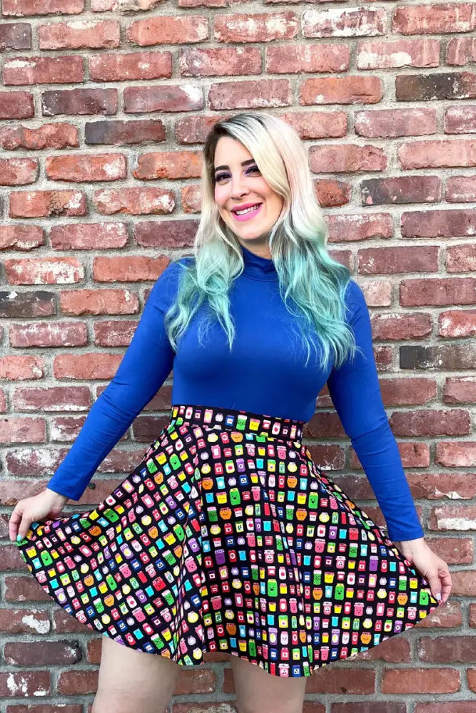 A vibrant flared skirt with colorful cartoon canned goods pattern paired with a royal blue vintage mock neck long sleeve top