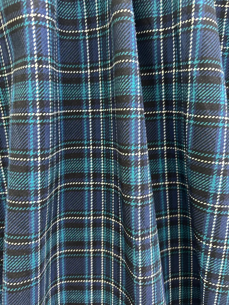 Blue plaid greta v neck cotton dress with pockets featuring navy blue and teal plaid fabric with black stripes and woven texture