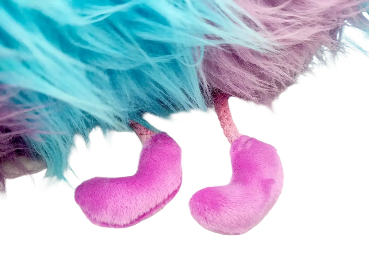 Blue and purple caterpillar plush toy with pink plush heart-shaped feet and pink braided cords attached