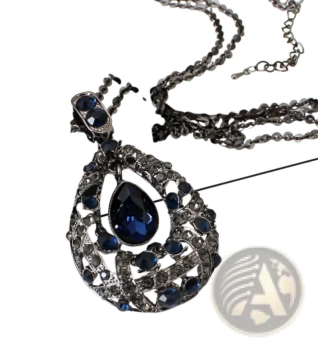 Elegant dark blue teardrop pendant necklace with intricate silver-toned filigree and sparkling gemstones on a sweater chain