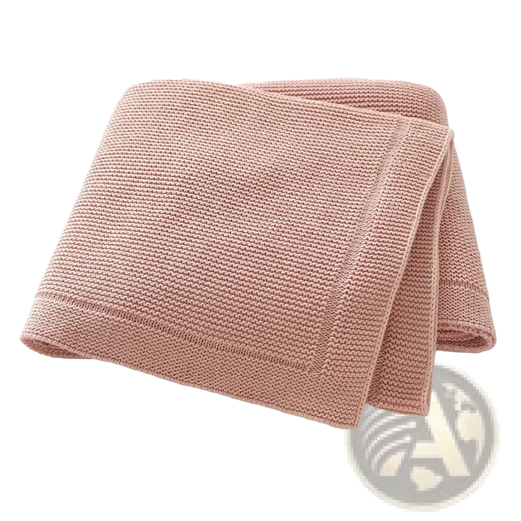Blush pink knitted baby blanket made of cotton with a textured waffle pattern and neatly finished edges