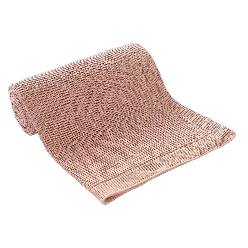 A blush pink knitted baby blanket made of cotton featuring a soft textured ribbed pattern for receiving use