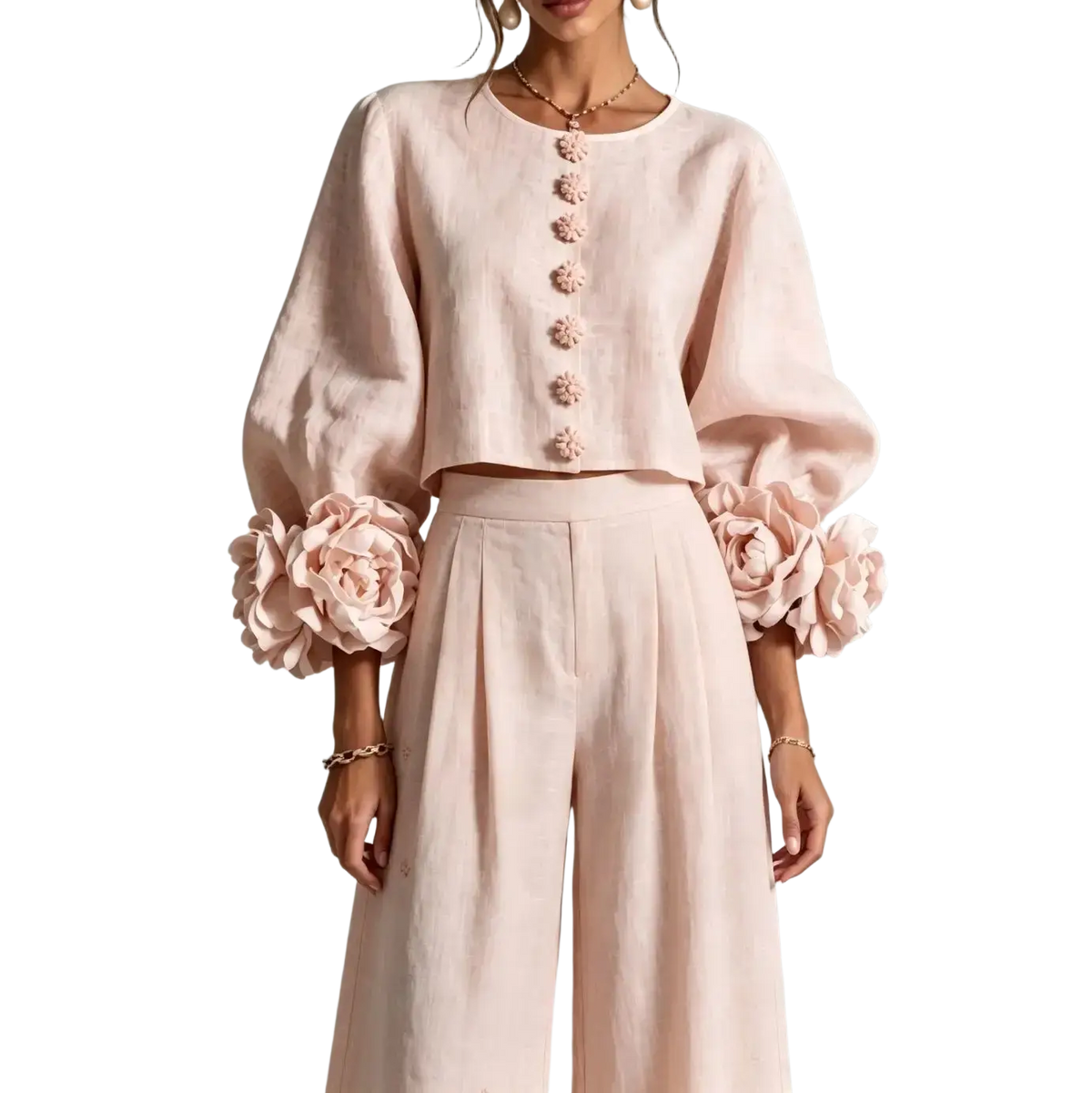 Soft pink linen crop top with puff sleeves and floral embellishments featuring matching decorative button closure