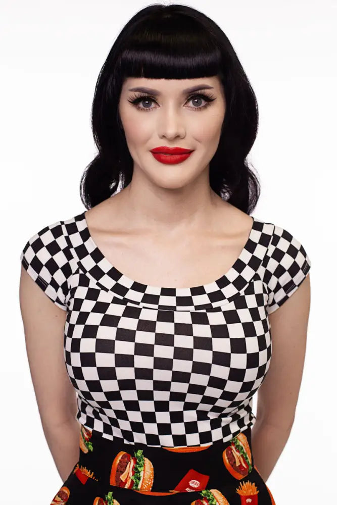 Vintage 1950s black and white checkered short-sleeved top with scoop neckline paired with colorful fast food skirt