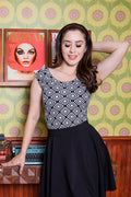 Black and white vintage geometric print sleeveless top with fitted bodice and flared skirt for stylish wear