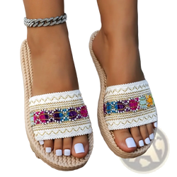 Beige woven espadrille bohemian beaded flat sandals with white embroidered strap and colorful sequined accents