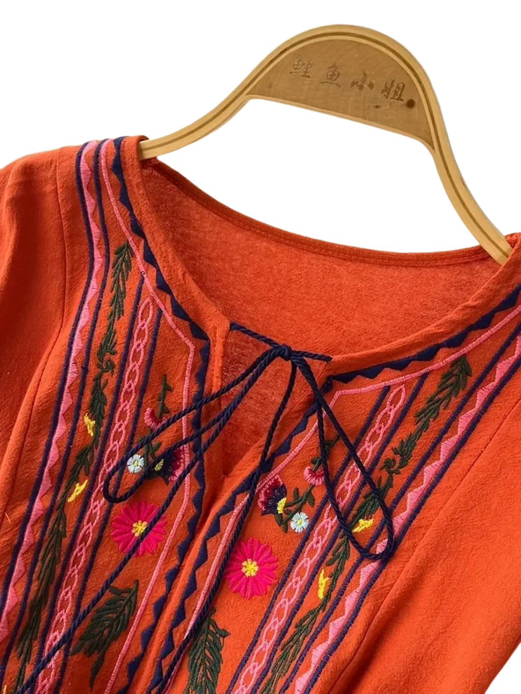 Bohemian embroidered long sleeve dress in orange with colorful floral and leaf patterns in pink green yellow and navy thread
