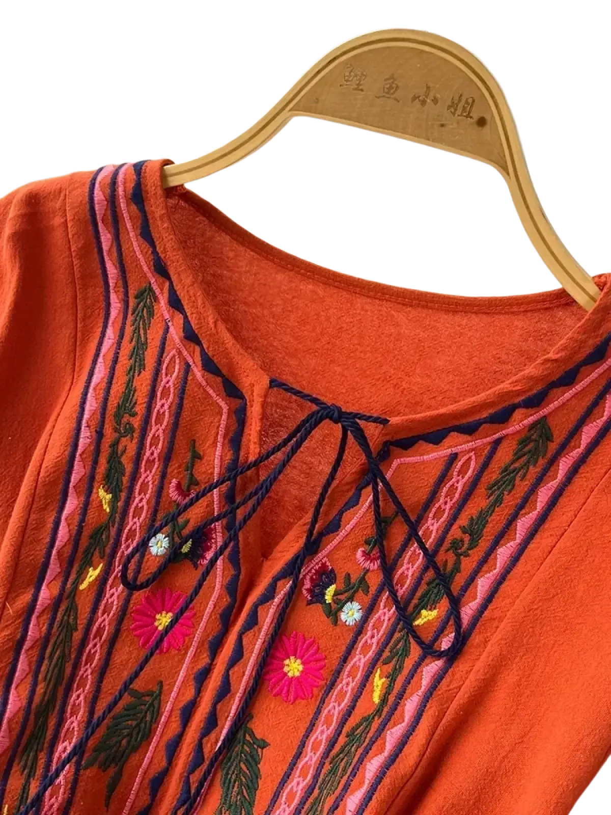 Bohemian embroidered long sleeve dress in orange with colorful floral and leaf patterns in pink green yellow and navy thread