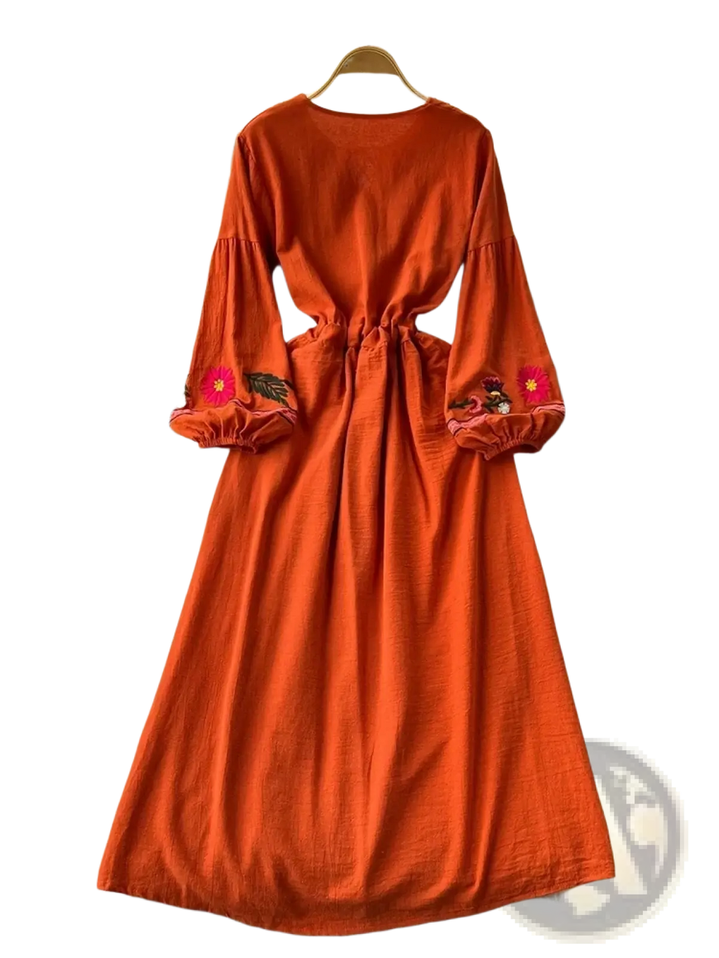 A vibrant orange bohemian long sleeve dress with floral embroidery on cuffs displayed on a hanger