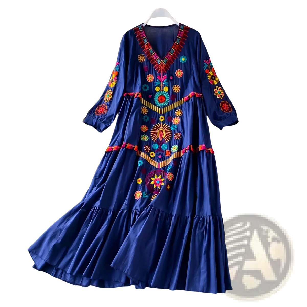 A vibrant royal blue bohemian embroidered v-neck maxi dress with intricate red yellow and turquoise floral patterns and three quarter sleeves