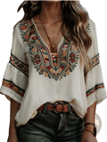 A cream-colored bohemian floral embroidered blouse with intricate earthy tone embroidery on neckline and sleeves