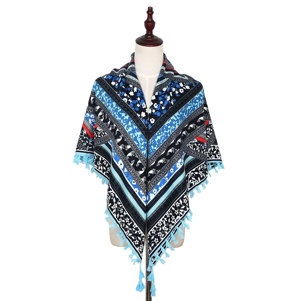 A vibrant blue and black patterned bohemian floral square scarf tassel shawl displayed on a mannequin