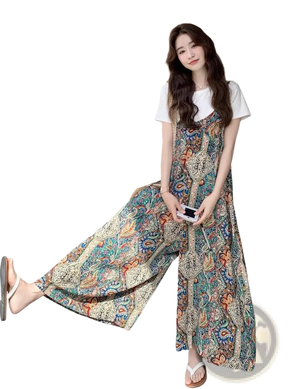 A flowing long-sleeved maxi dress with vibrant teal orange and cream paisley pattern in bohemian floral style