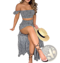 A woman wearing a black and white two-piece off-shoulder floral set paired with strappy black sandals