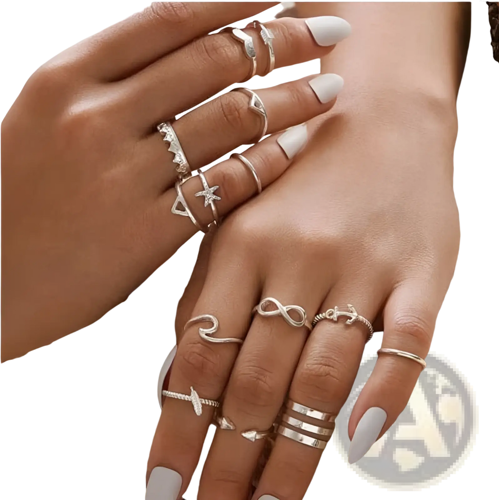 A bohemian silver mixed motif stackable ring set featuring silver-toned rings with infinity, anchor, star, and geometric designs
