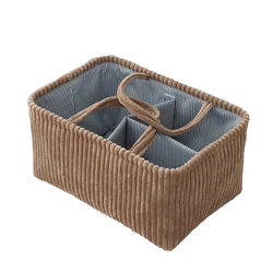 Beige corduroy bohemian storage basket with striped blue interior and woven handles for multi compartment organization
