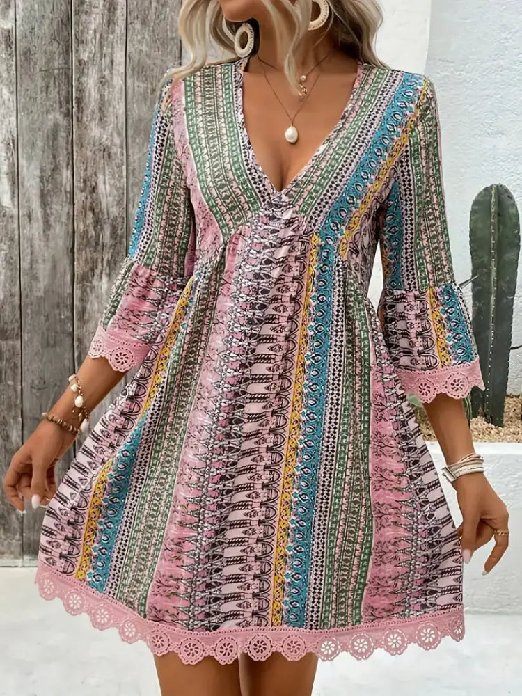 A vibrant multi-colored embroidered bohemian v-neck lace trim beach dress with vertical stripes and bell sleeves