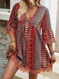 A vibrant red blue and beige embroidered bohemian v neck lace trim beach dress with lace cuffs and hem