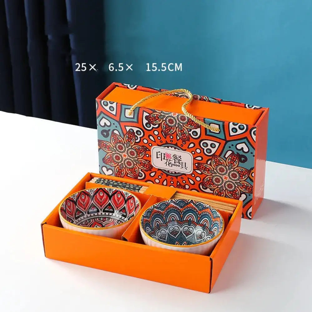Two ceramic bowls with colorful floral mandala patterns in red black and blue white in an orange gift box