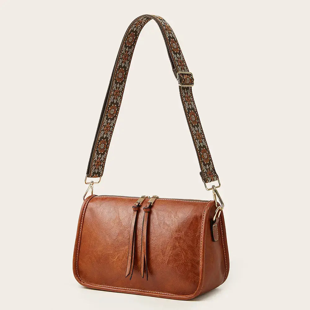 Brown faux leather aztec embroidered bohemian crossbody bag with patterned strap and tassel details