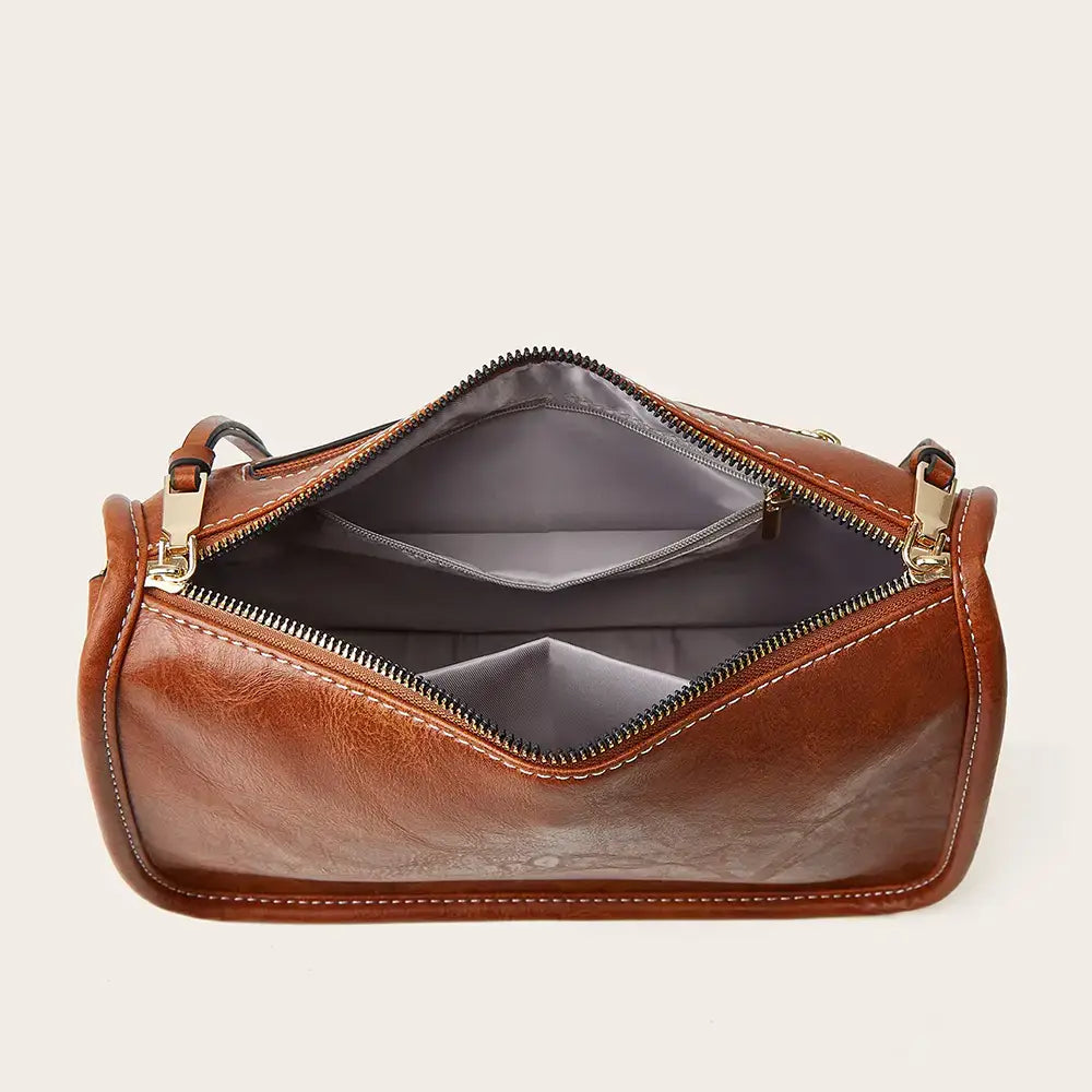 Brown leather aztec embroidered bohemian crossbody bag with gold-tone zippers and detailed stitching