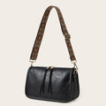 Black faux leather crossbody bag with an aztec embroidered brown and beige wide bohemian strap