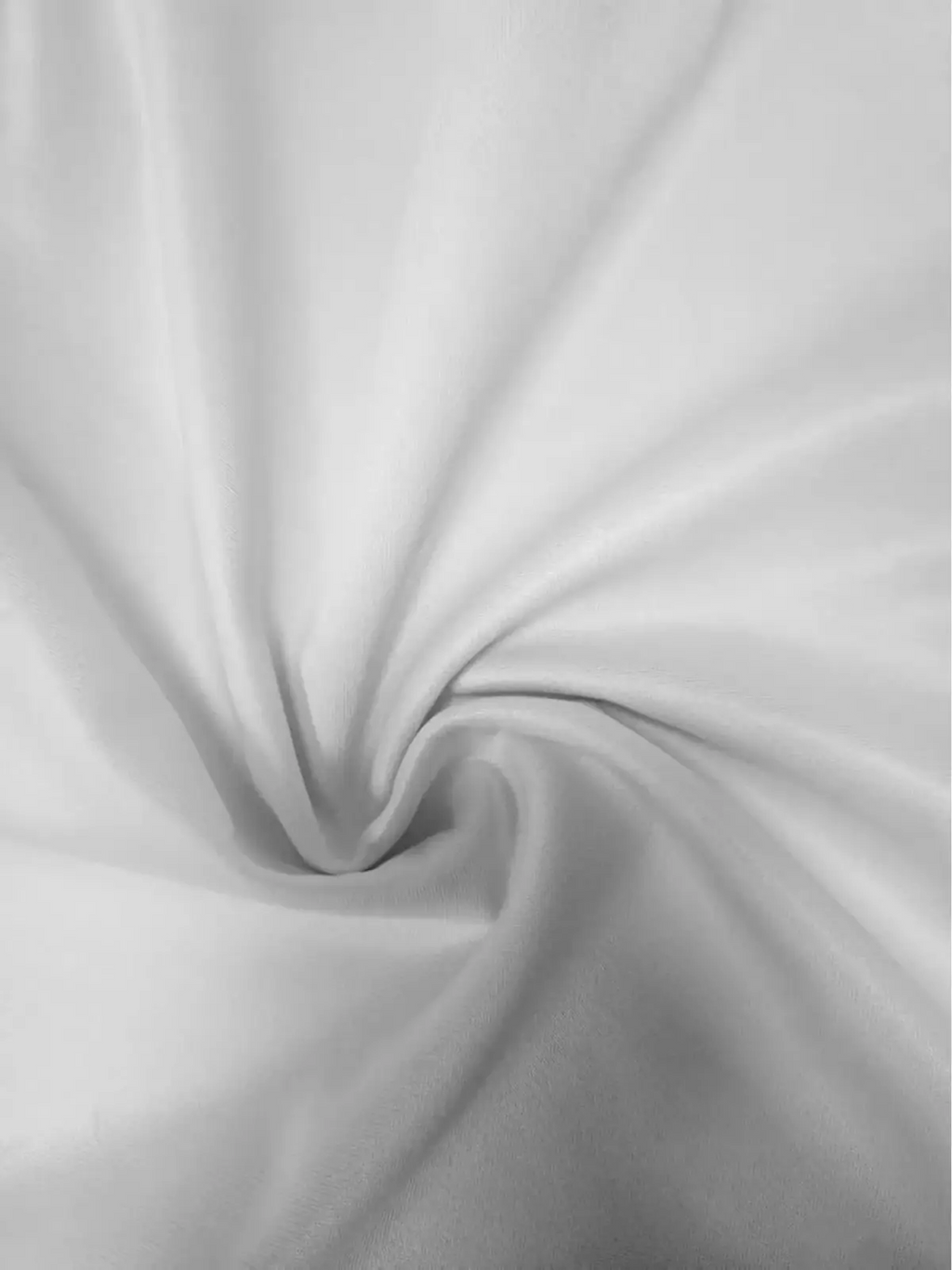 A smooth white boho beach dress with spaghetti straps and subtle sheen fabric perfect for summer vacation