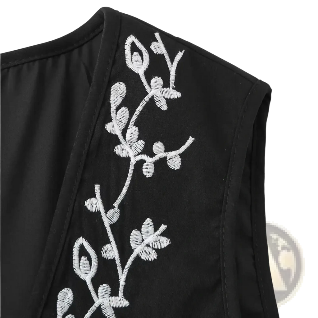 Black sleeveless boho floral embroidered quilted vest with delicate white embroidered floral vines along the side