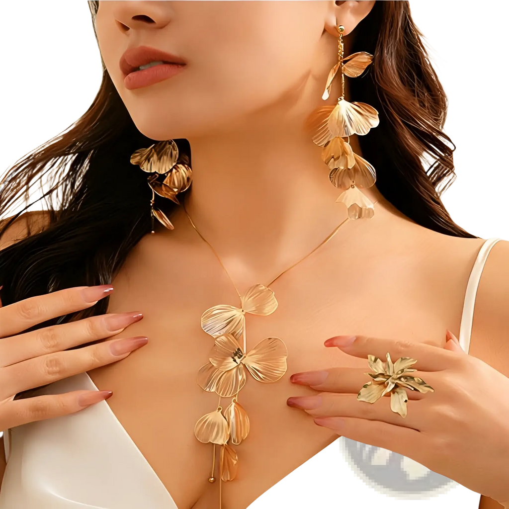 Boho gold ginkgo leaf tassel necklace and earring set featuring golden layered leaf design with delicate chain and cascading petals