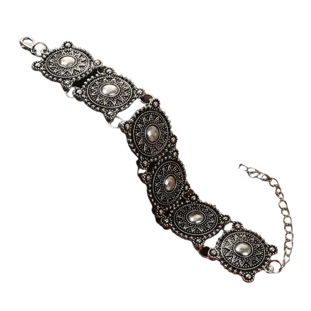 Antique silver-toned boho bracelet with intricate geometric and floral patterns and central oval embellishments