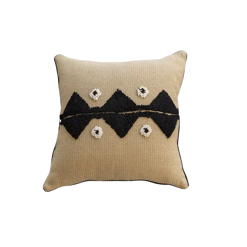Beige boho throw pillow cover with black geometric embroidery and white pom-pom accents for living room decor