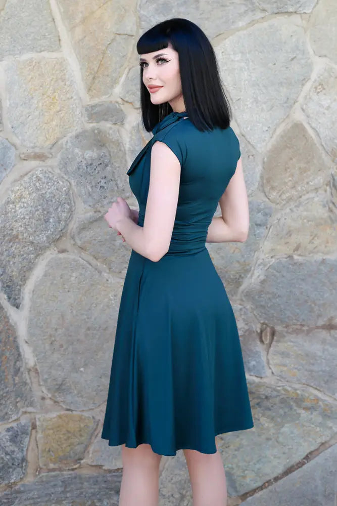 Spruce green bombshell satin sleeveless retro flare dress with fitted bodice and bow at neckline in teal