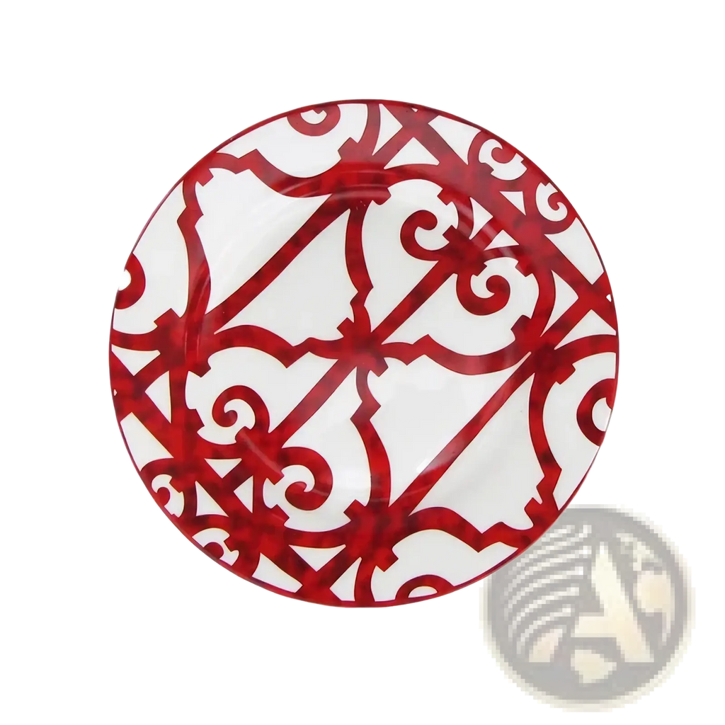 A round bone china red scroll dinner plate with a bold red and white ornate lattice pattern