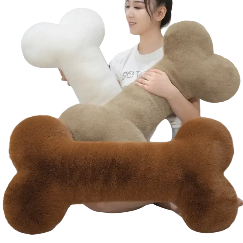 A plush fuzzy brown bone shape plush pillow with soft textured surface perfect for naps and comfort