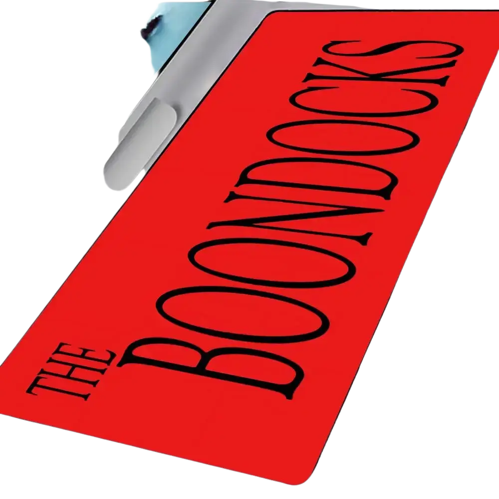Red rectangular rubber gaming mouse pad with bold black the boondocks text in a stylized serif font