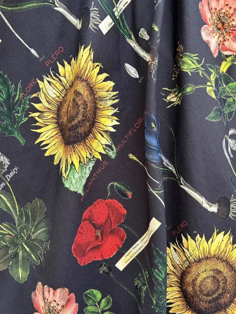 Botany vintage floral sleeveless cotton dress with pockets in dark fabric featuring vibrant sunflower and poppy prints