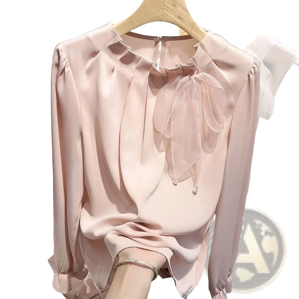 A soft blush pink satin bow chiffon blouse with ruffled neckline and sheer bow detail for elegant office wear