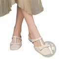Cream-colored leather bow closed toe mule flats for women featuring square toe and t-strap design