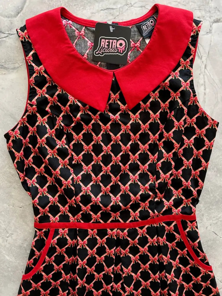 Retro bow print cotton sleeveless a-line dress with black and red geometric pattern and bright red peter pan collar