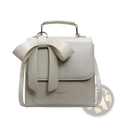 A sleek off-white faux leather bow crossbody bag with silver-toned hardware and a prominent front bow detail