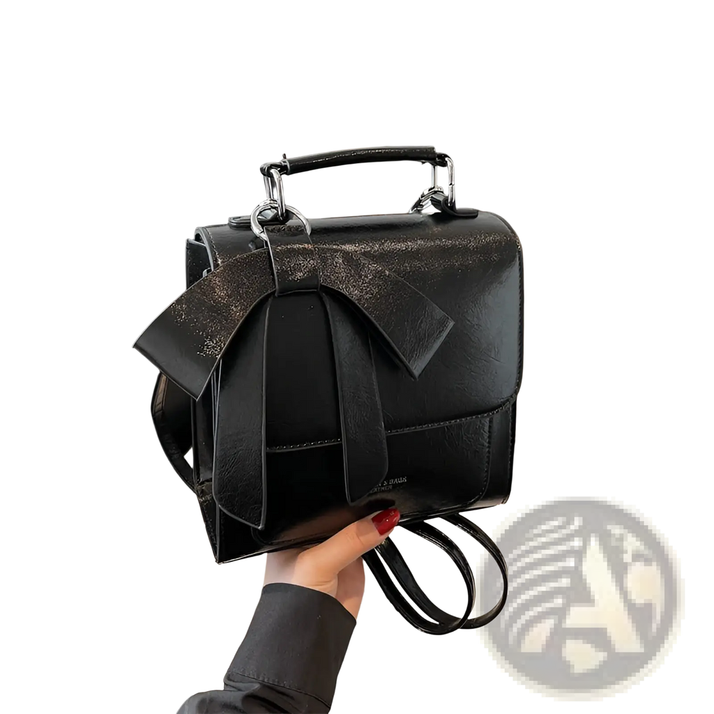 Black faux leather bow crossbody bag with glittery bow and silver toned hardware for fashionable use