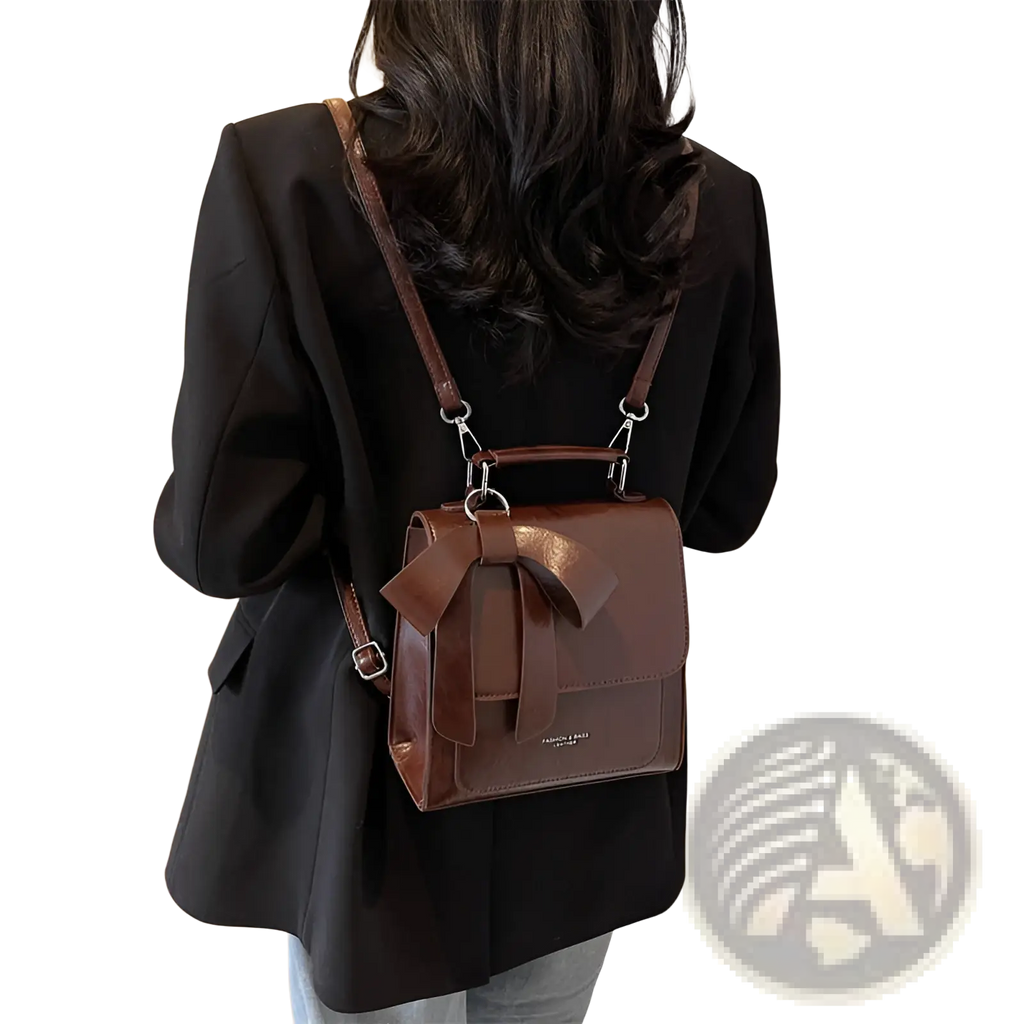Brown leather bow crossbody bag made of faux leather featuring a prominent bow on the front for fashion use