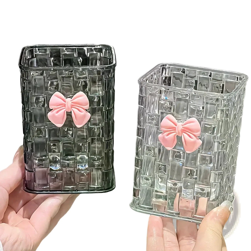 Transparent glass rectangular pen holder with woven texture and pink bow accents for desktop storage organizer