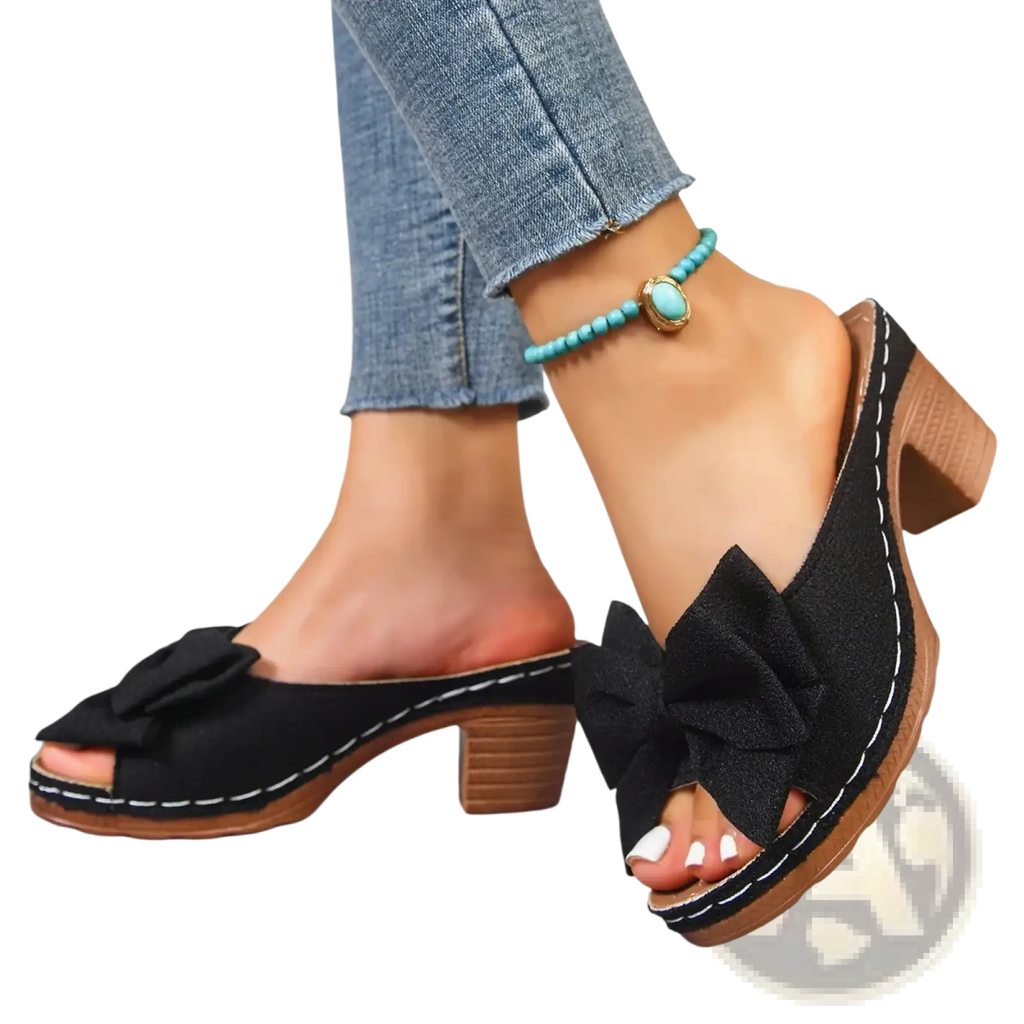 Black bow-adorned platform mules with wooden block heels and white stitching for stylish block heel sandals