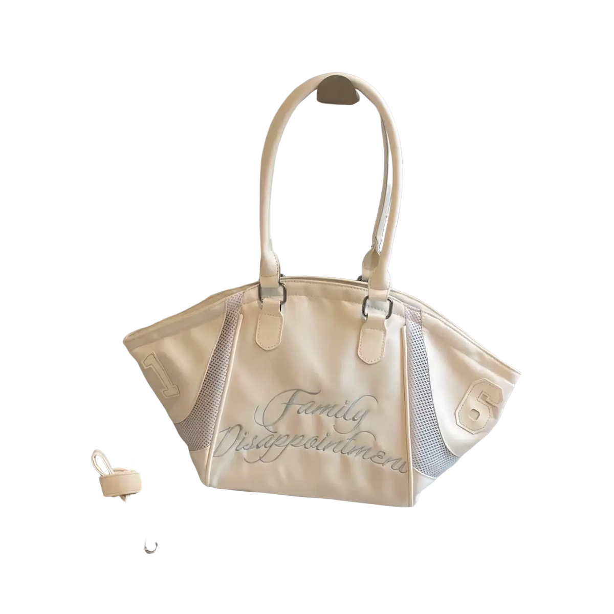 Cream-colored canvas bowling bag tote with mesh side panels and silver embroidered family disappointment text