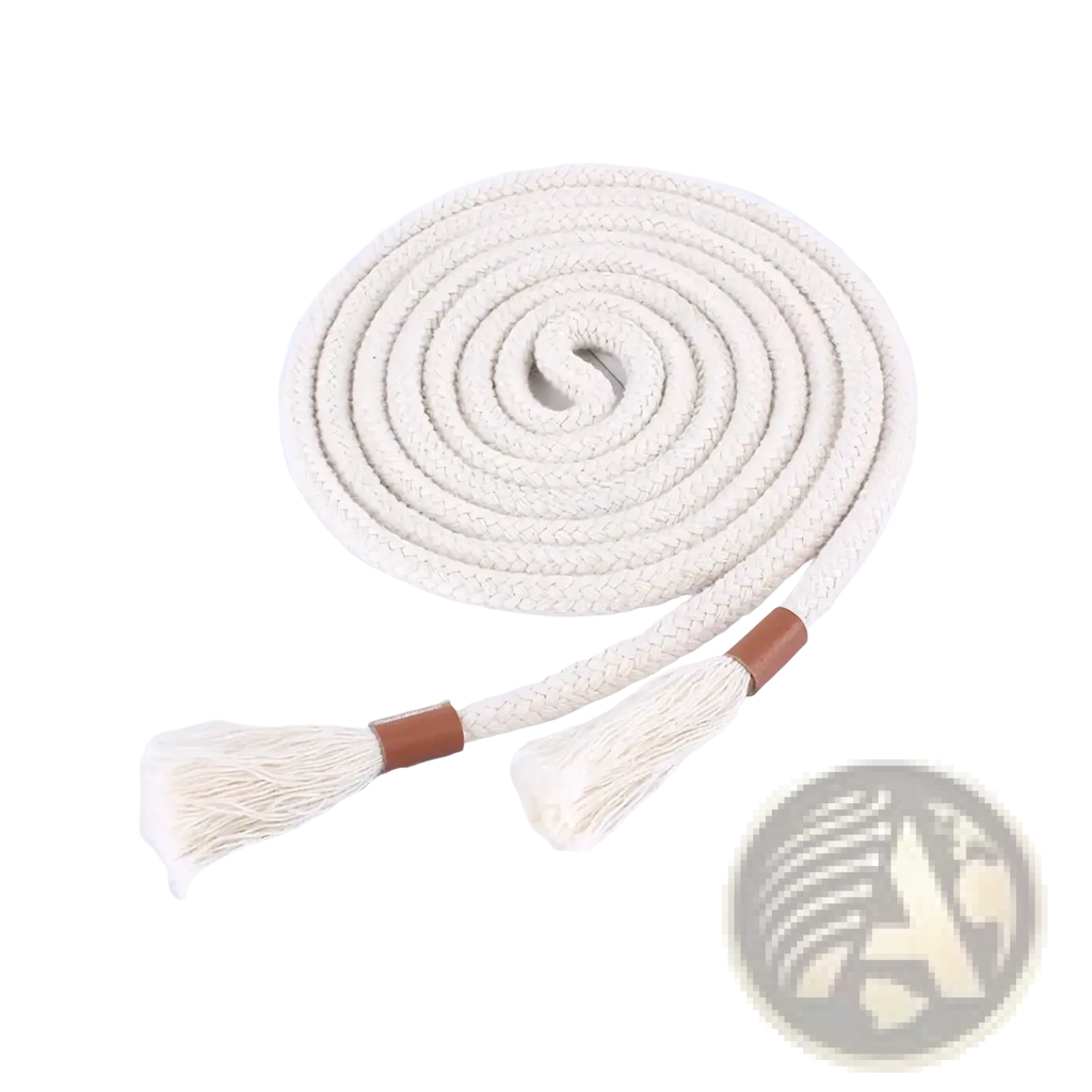 Cream-colored braided rope belt with tassels and brown leather ends coiled on a magazine page for women dress accessory