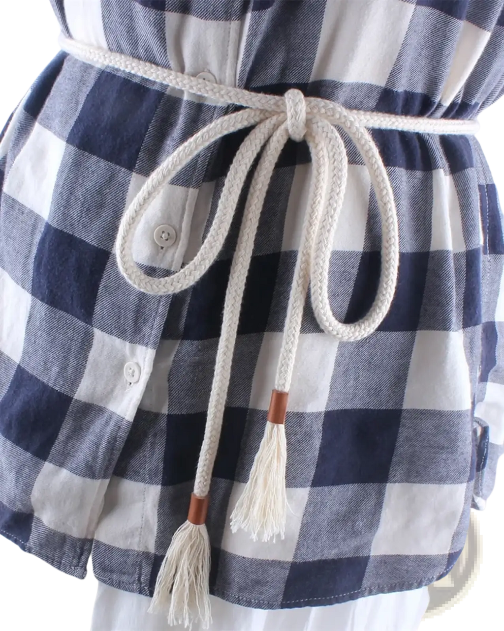 Cream-colored braided rope belt with wooden toggle ends and tassels worn around the waist of a blue plaid shirt
