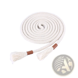 Cream-colored braided rope belt with tassels and brown leather ends coiled on magazine page for women waistband accessory