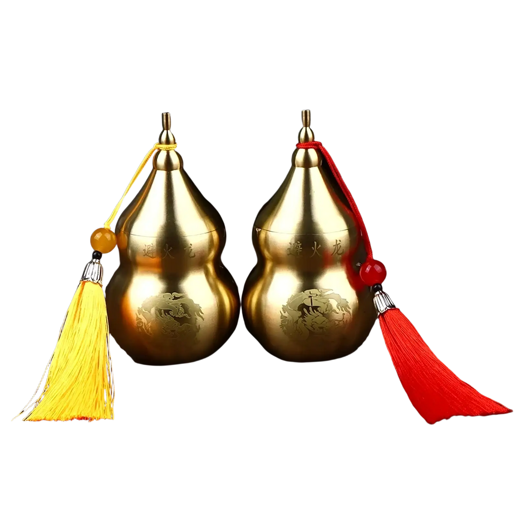 Brass gourd feng shui prosperity ornaments in gold with engraved chinese characters and decorative tassels in yellow and red
